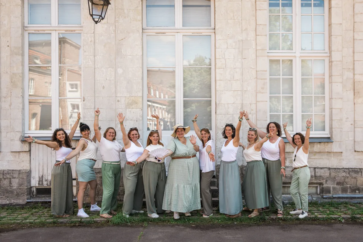 Photo de groupe EVJF dynamique avec accessoires et tenues coordonnees en centre ville de Lille